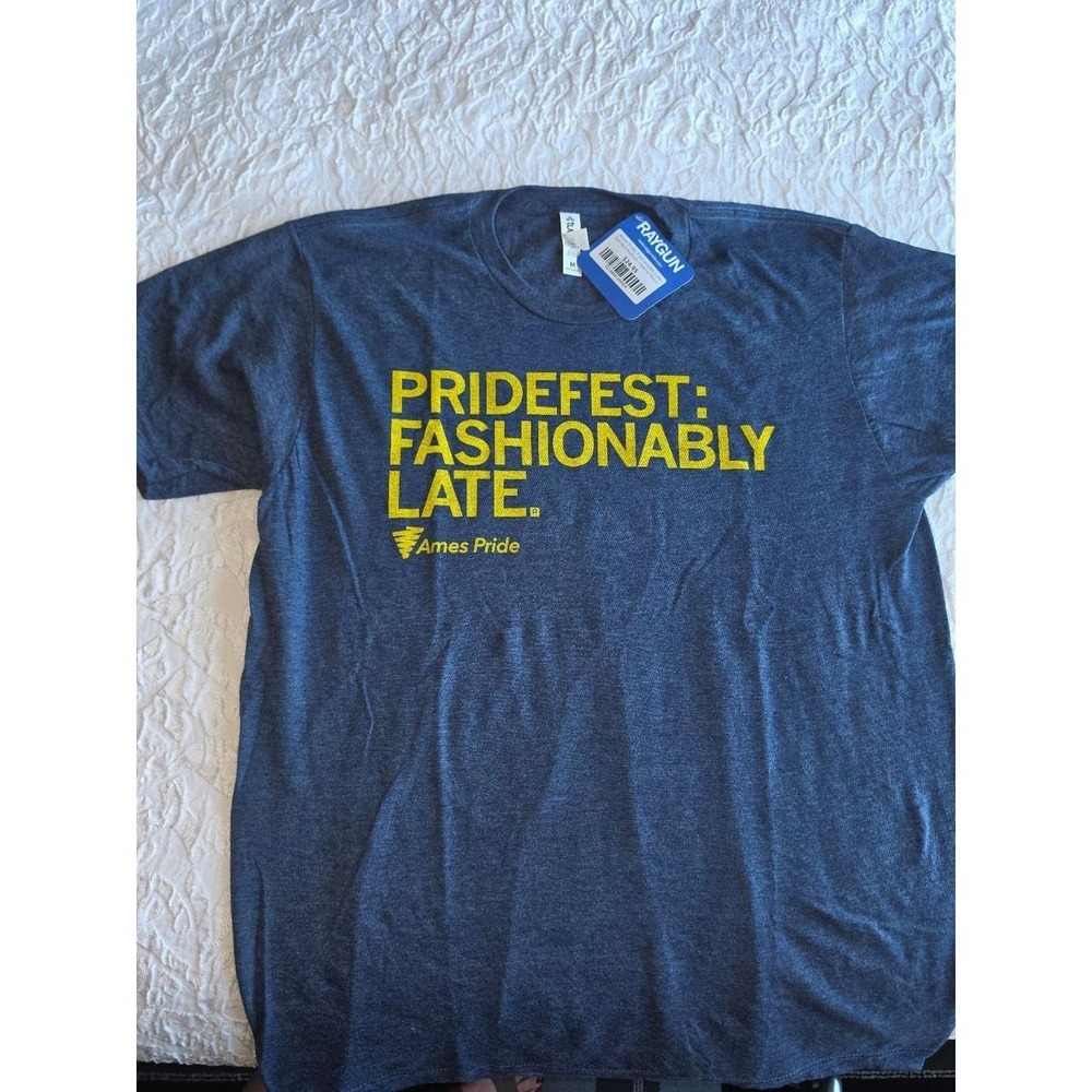 blue heather Raygun t-shirt features yellow "PRIDEFEST: FASHIONABLY‎ LATE."